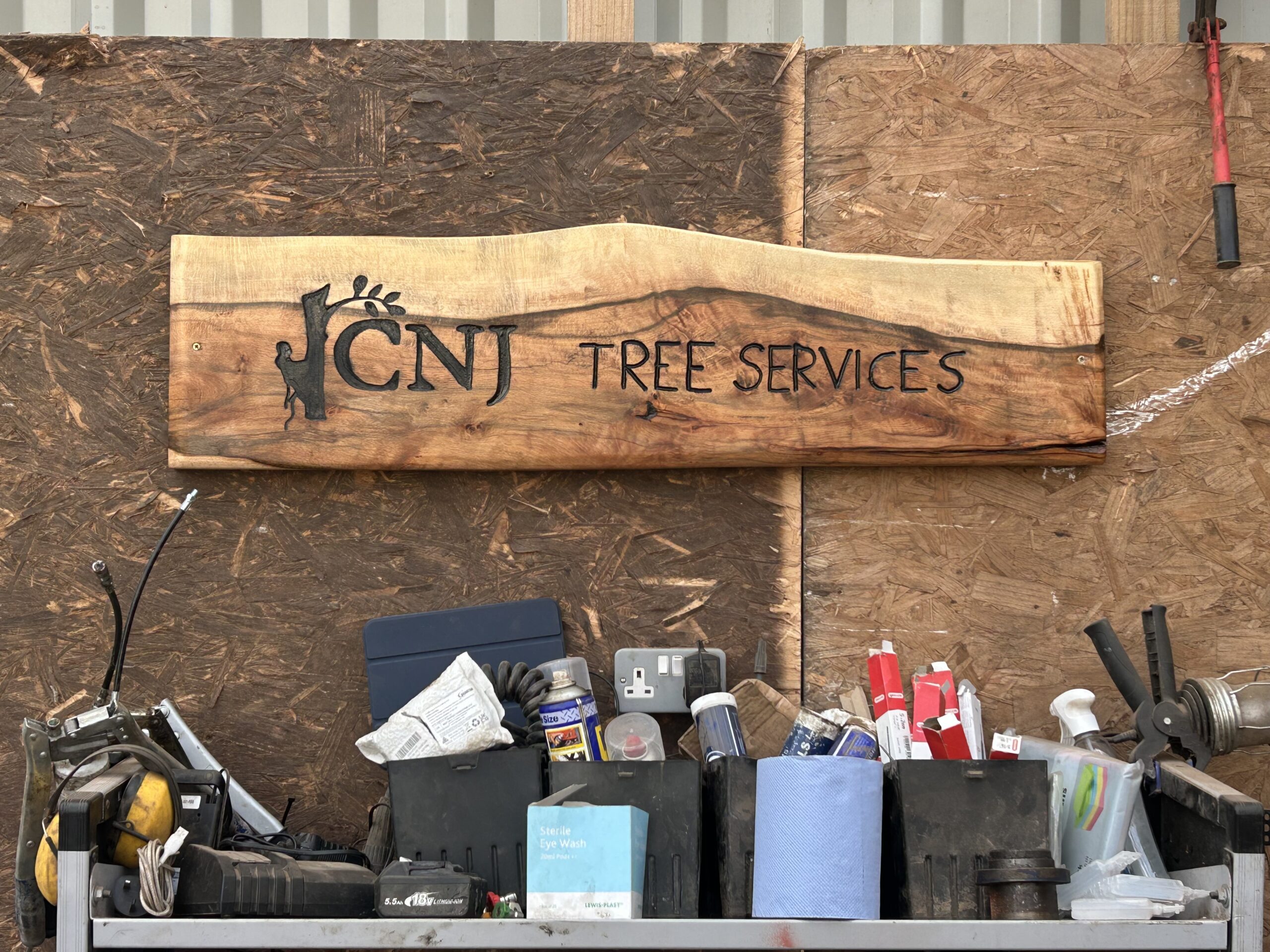 cnj tree services carved wooden sign in workshop