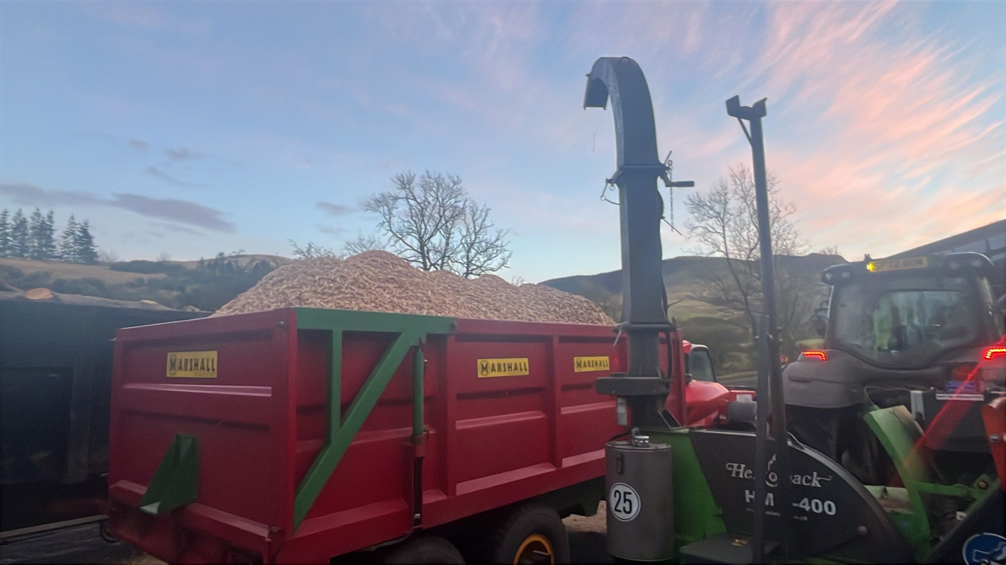 trailer piled high with wood chip mulch